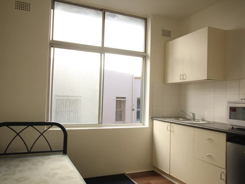 Partly furnished single boarding house room with shared bathroom