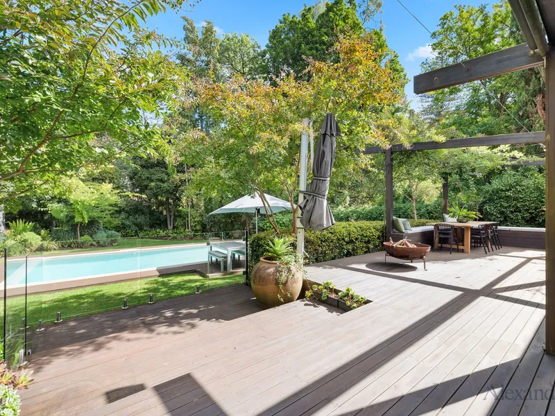 A spectacular five bedroom family home set in a private sanctuary of 1,365sqm (approx.) with a sparkling inground pool.