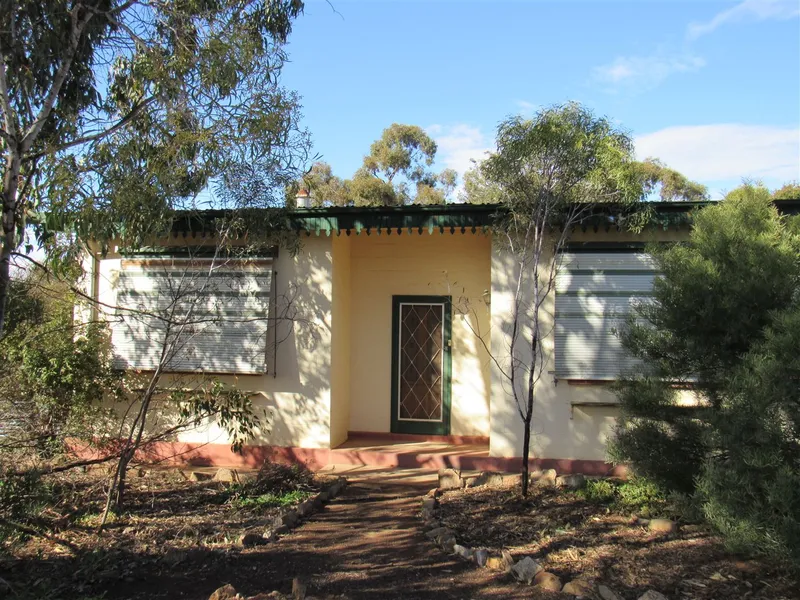 Rendered Stone Home with Brick Extension