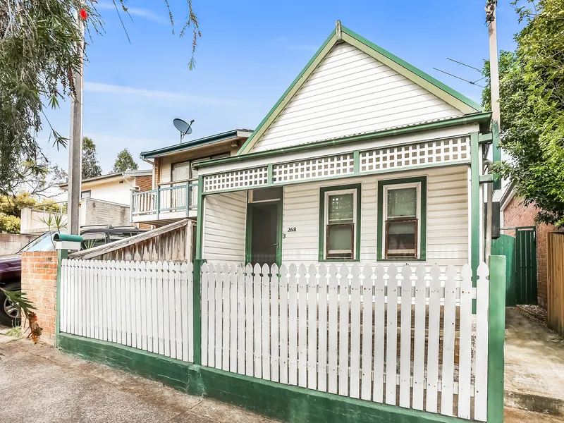 Unrenovated freestanding home with two street frontages