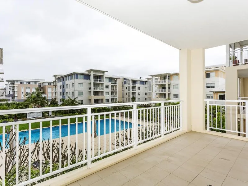 Generous two bedroom with media area and pool views