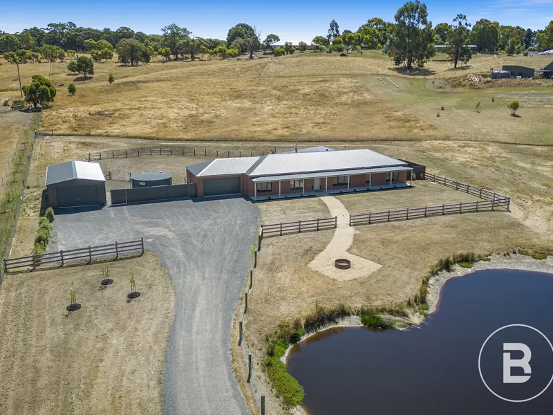 STUNNING BRIAN AND PETERSON HOME WITH EXTENSIVE SHEDDING ON APPROX. 5 ACRES