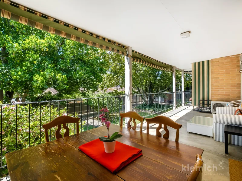 Spacious two-bedroom apartment with private balcony in a leafy garden setting. 