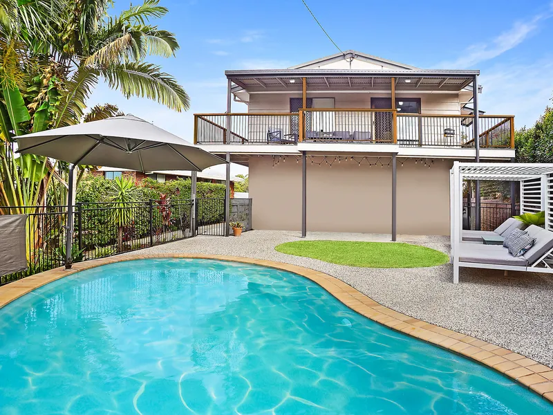 Come home to an elevated quarter-acre block with coastal breezes, sea glimpses, and dual-living potential