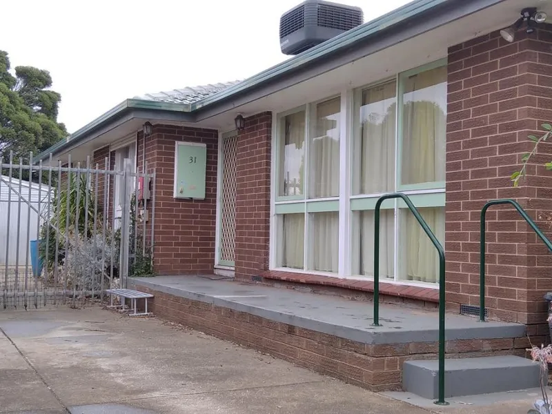 Three-bedroom house with oversized garage shed and covered side pergola