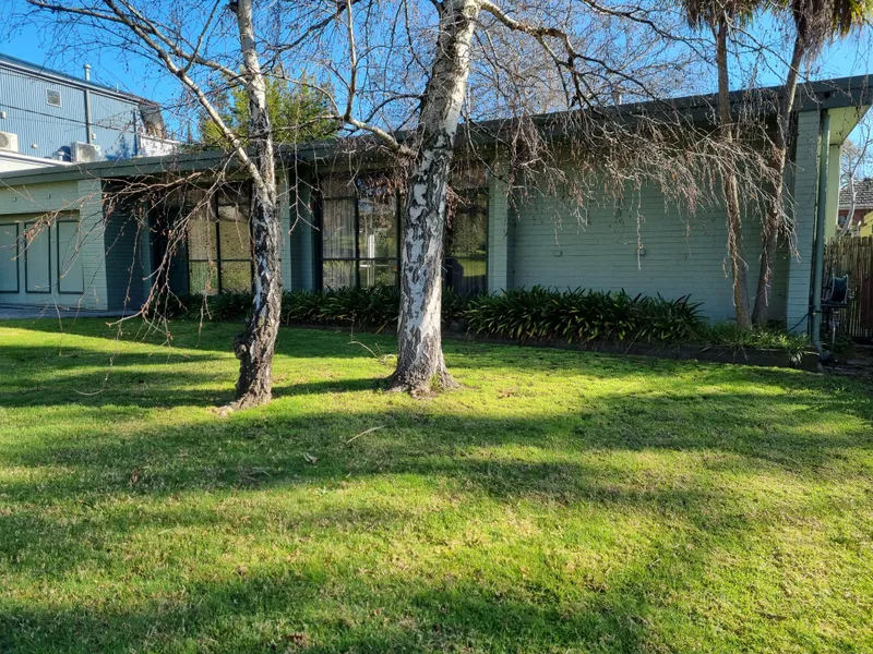 Ideally situated 60’s style home with the option of a 3rd bedroom or home office