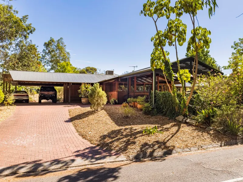 Make over modernist magic with a pool & court on a wooded 1834sqm corner block