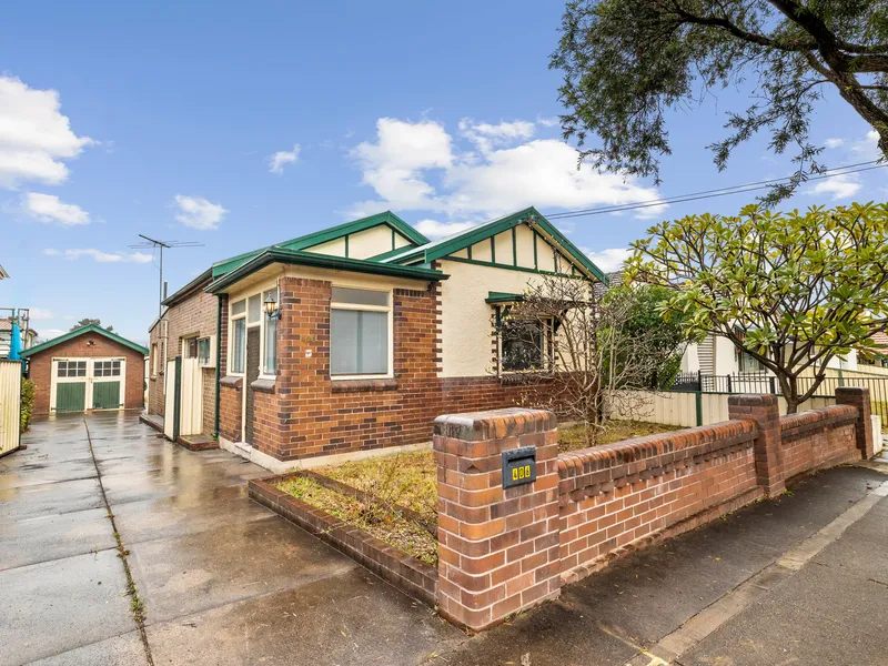 Charming Family Home with Sunroom, Potential for Third Bedroom, and Convenient Location