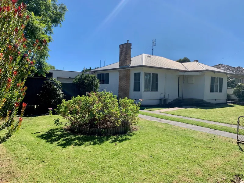 Older home with a variety of sheds