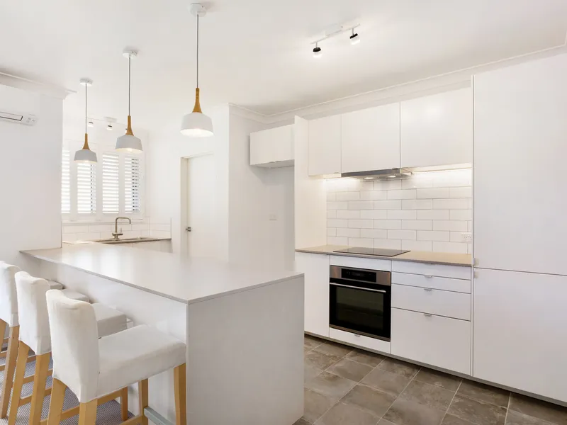 Completely renovated designer top floor apartment finished to a high standard. 600 metres to sand and surf.