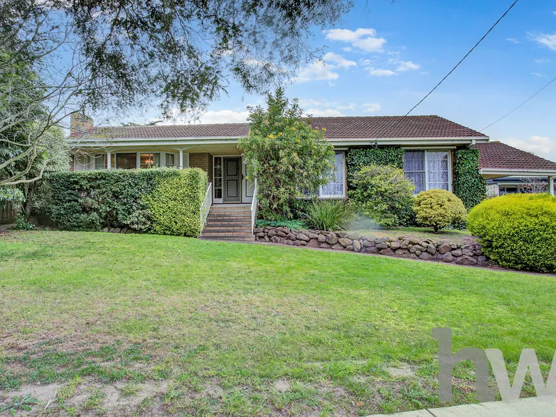 Charming three-bedroom home with Large Backyard!
