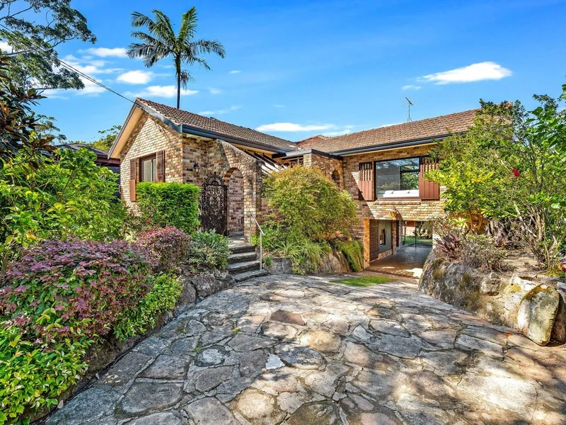 Brick residence with stunning leafy water views