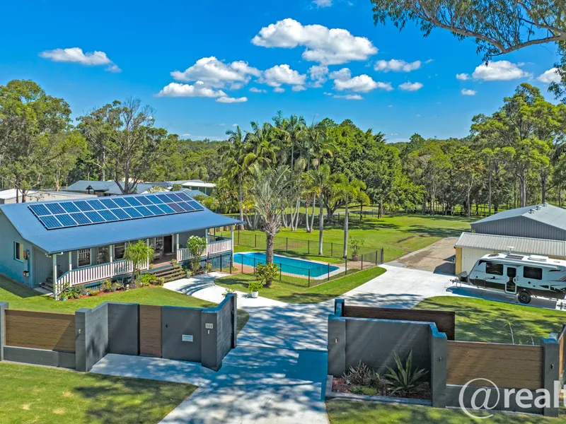 Superb acreage opportunity with pool and massive shed!