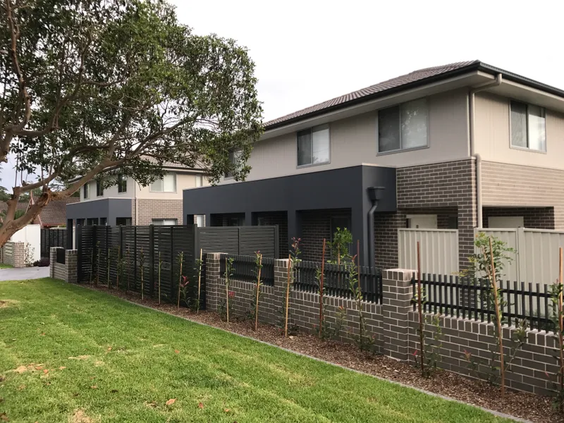 Near New 4 bedroom townhouse with ducted air conditioning & double garage.