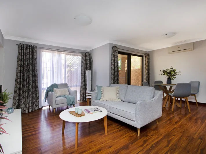Newly painted villa offers open plan living with vinyl wood flooring throughout.