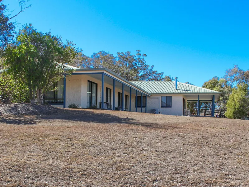 65.6 Acres of Prime Land with Mountain Views & Dual Living Homestead. 