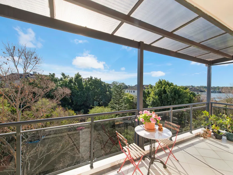 Sun-drenched top floor apartment with water glimpses