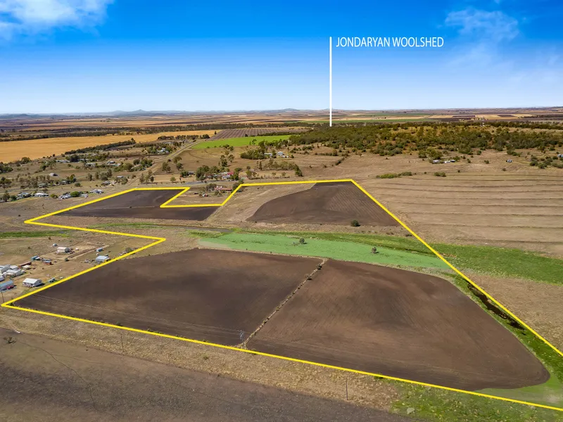 50* acres in 2 separate titles with town water, Lagoon Creek & quality growing soil!