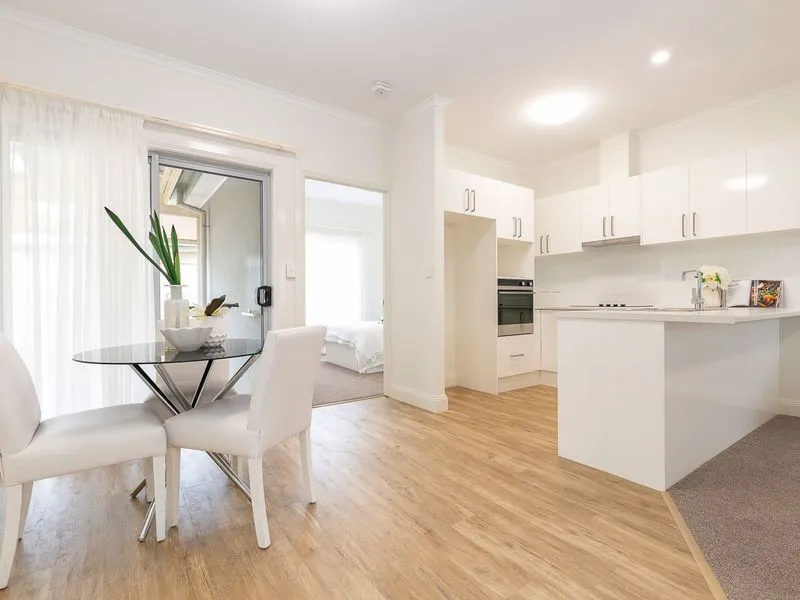 Enjoy the beautiful gardens and palm trees in this renovated 