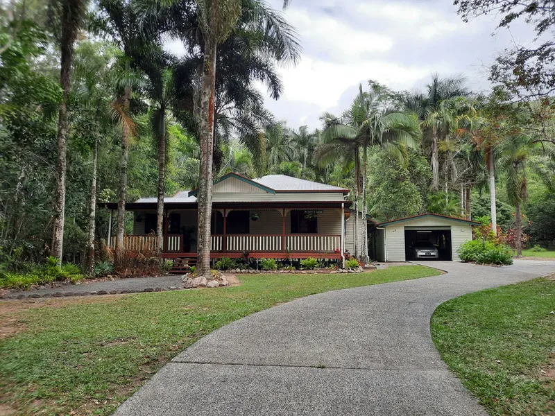 Unique Queenslander on 1.22 level acres set in tropical gardens with 4 sheds. Ideal for any business or luxury resort style living....or both.