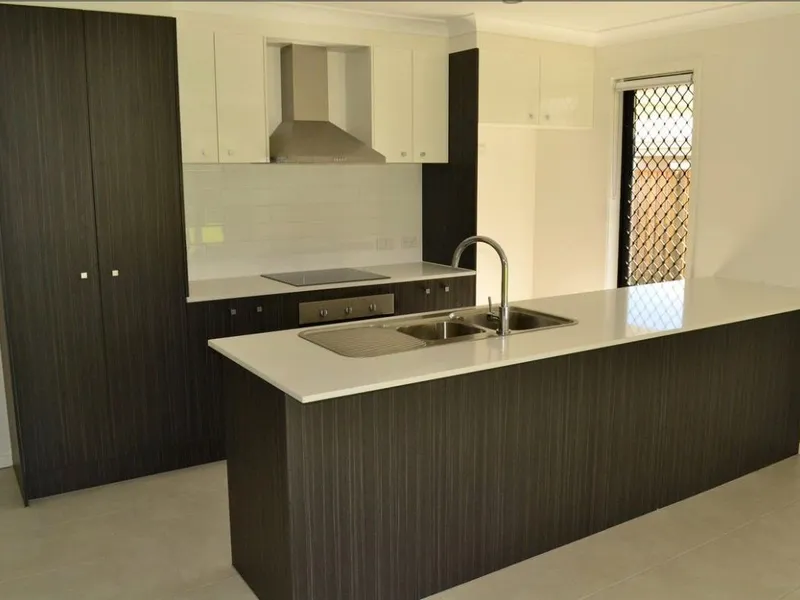 LOW MAINTENANCE THREE BEDROOM UNIT WITH AIR CON AND SPACIOUS BACK YARD!