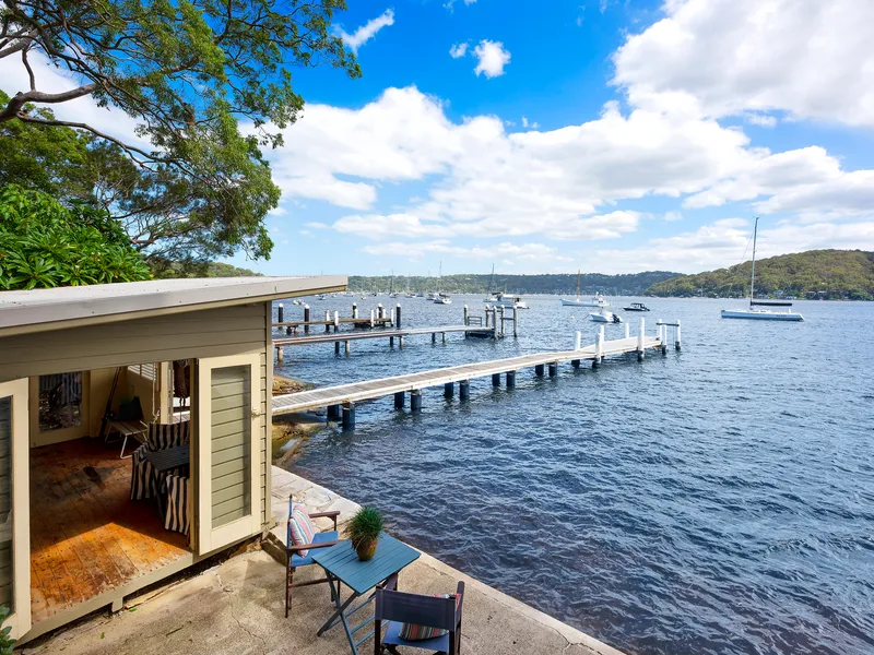 Blue-ribbon Pittwater Setting with deep-water jetty and boathouse