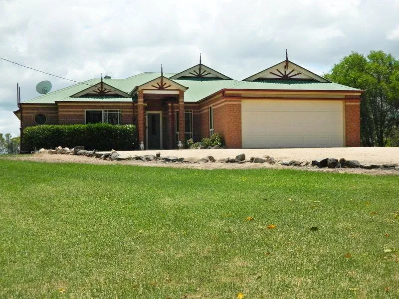 Large quality brick home on 105 acres on a hill boasting magnificent 360 views .