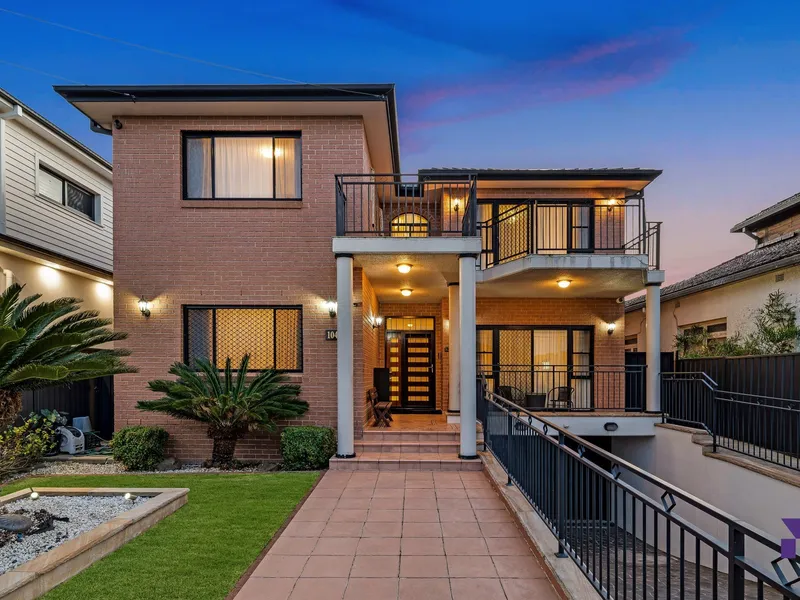 Full-brick family entertainer with basement parking peacefully enjoys a sought-after address