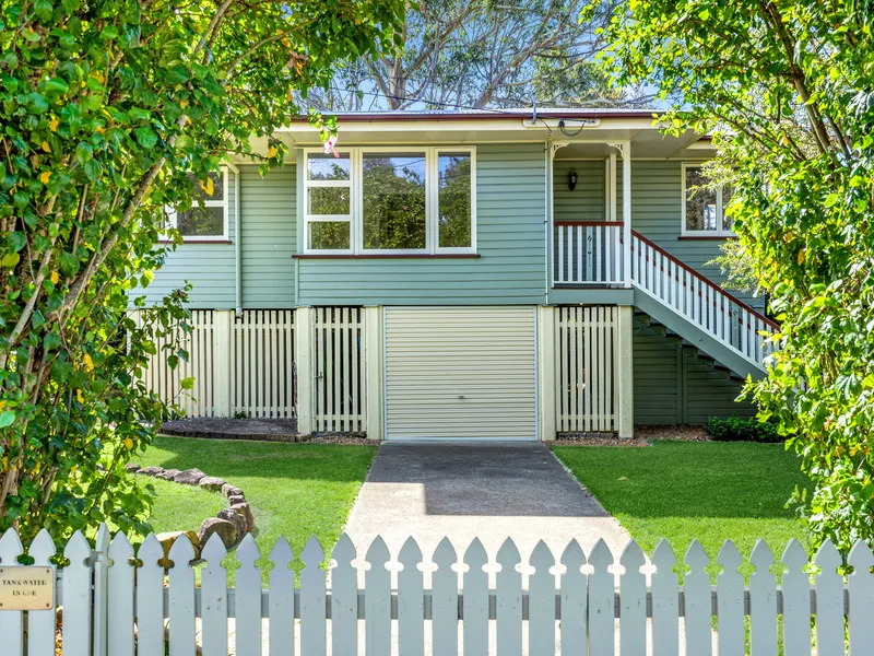 Charming home within a lush green setting.