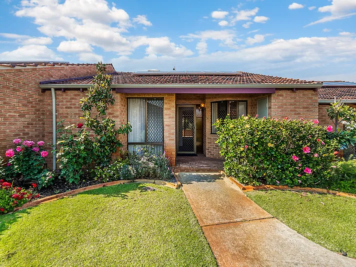 Well-presented cottage style home set amongst manicured gardens.