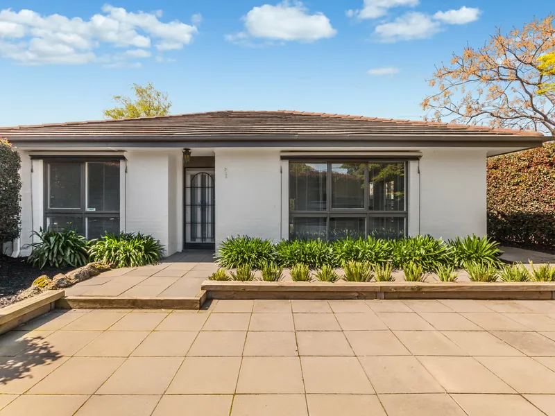 Charming single level residence in picturesque garden setting.