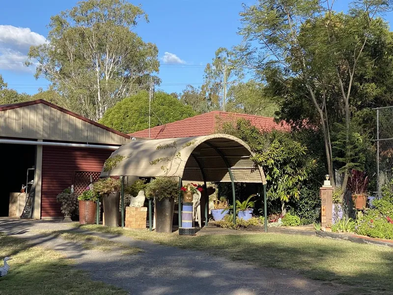 RARE FIND -Brick Home with Beautiful Gardens Set on a Picturesque 5 Acre Property with one of the most important things for acreage living WATER. 