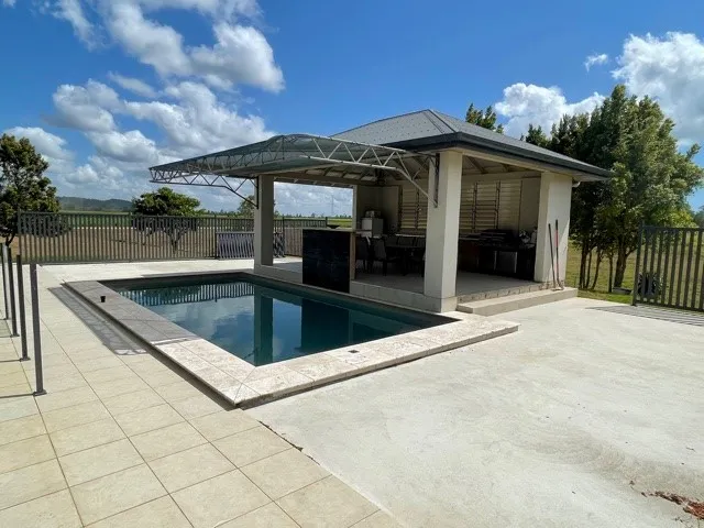 EXECUTIVE STYLE LIVING IN TROPICAL SURROUNDS WITH ABUNDANT RAINFALL AND EXCELLENT IMPROVEMENTS