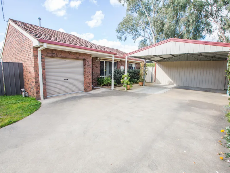 Generous unit with double carport and garage
