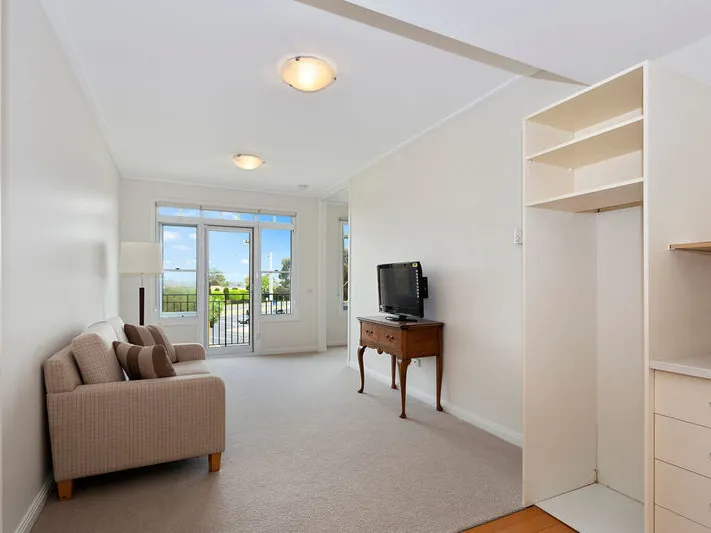 Light filled second floor apartment with balcony.
