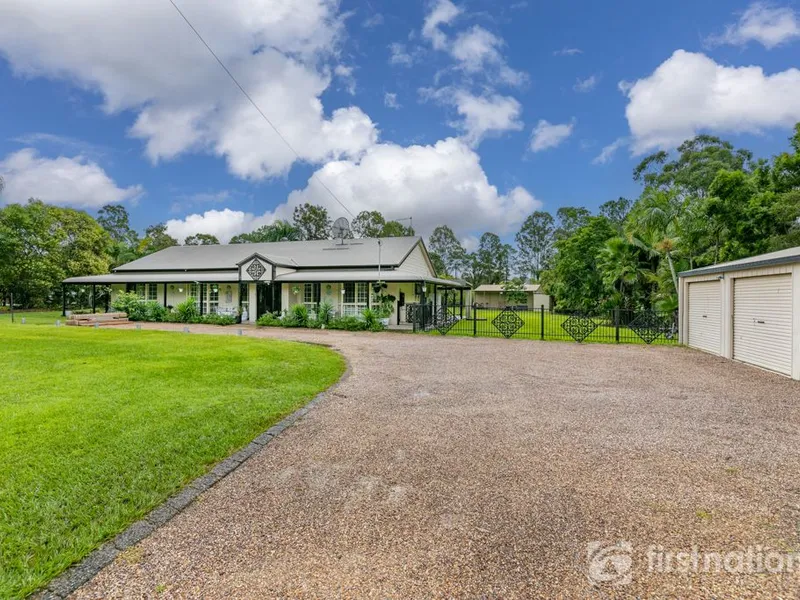 Stunning 5 bedroom home located on 2 Acres with sheds & inground pool!