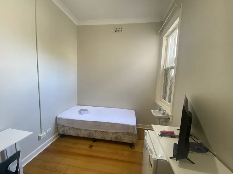 A Boarding House with a furnished room available.