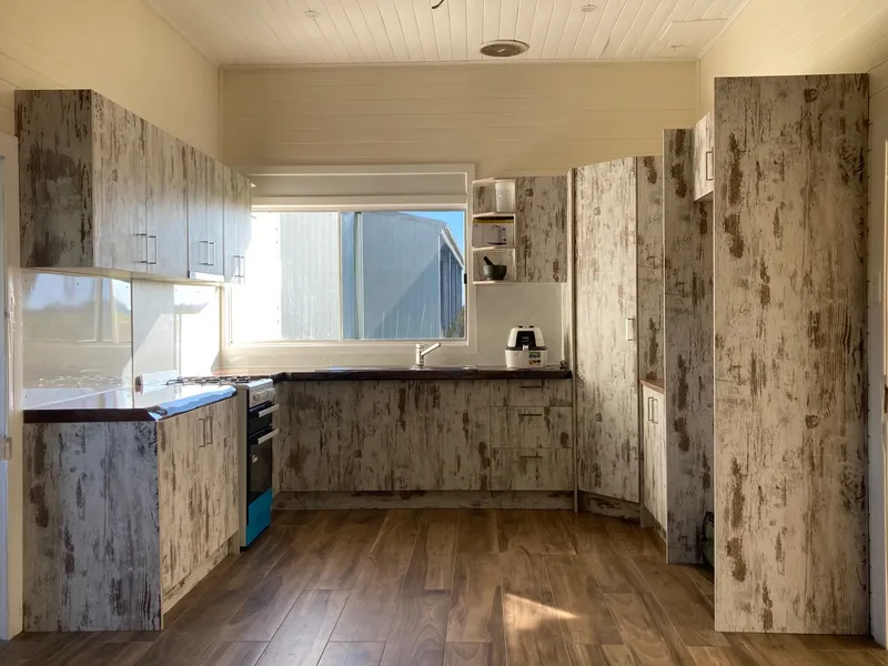 Older style farmhouse with high ceilings and enclosed verandahs, completely renovated interior