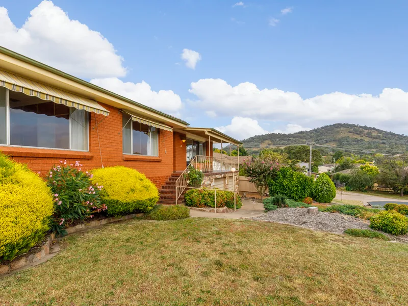 Elevated three bedroom home on a beautiful 1086m2 land holding.