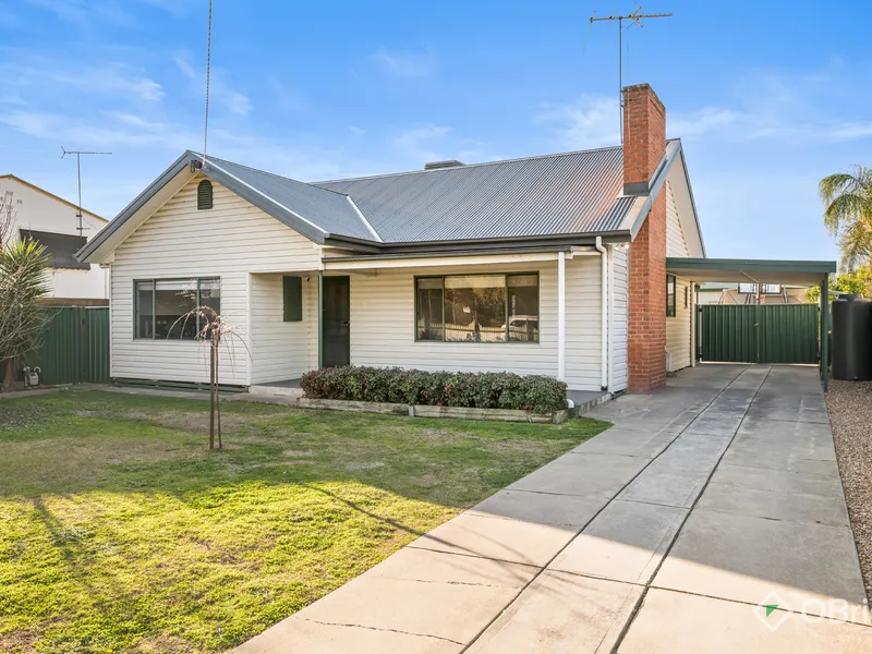 Renovated home with a large shed.