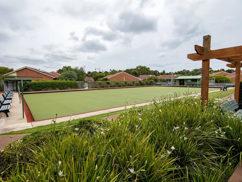Living area with natural light surrounded by lush gardens