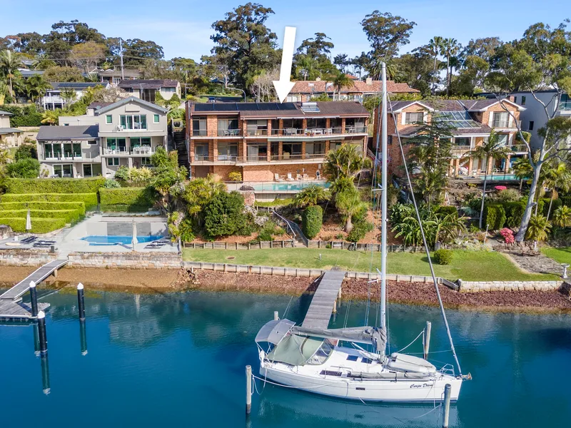 Architecturally designed + deep waterfront setting