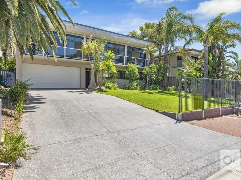 Escape to a two-storey 'sea change' in a resort-like setting, metres from the sand.