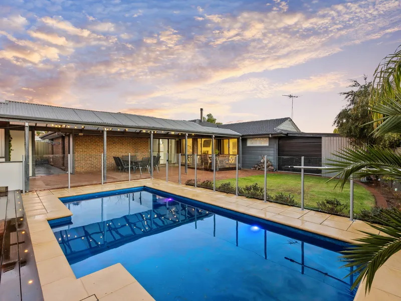 Elegant living featuring a sparkling inground pool!