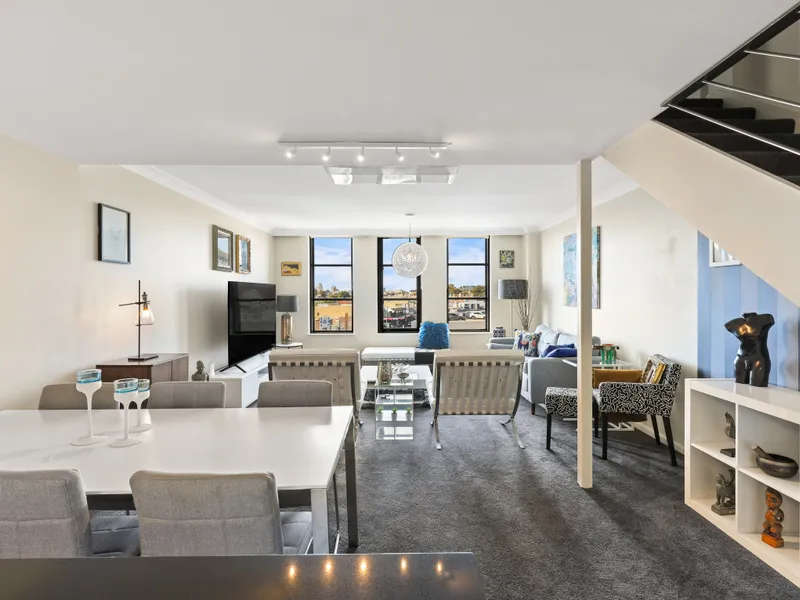 Dual level loft with an alluring city backdrop