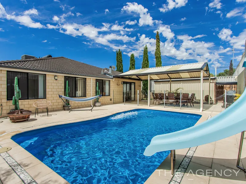 Modern family home with a pool and workshop in Comet Bay