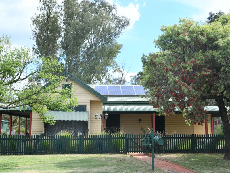 COUNTRY STYLE RESIDENCE WITH RIVER FRONTAGE IN TOWN!