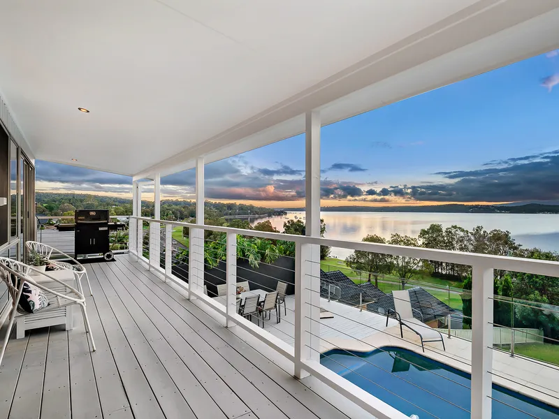 Cinematic Lake Views Frame this Multi-Level Home