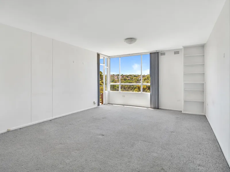 Spacious light filled apartment with expansive district and distant views. 