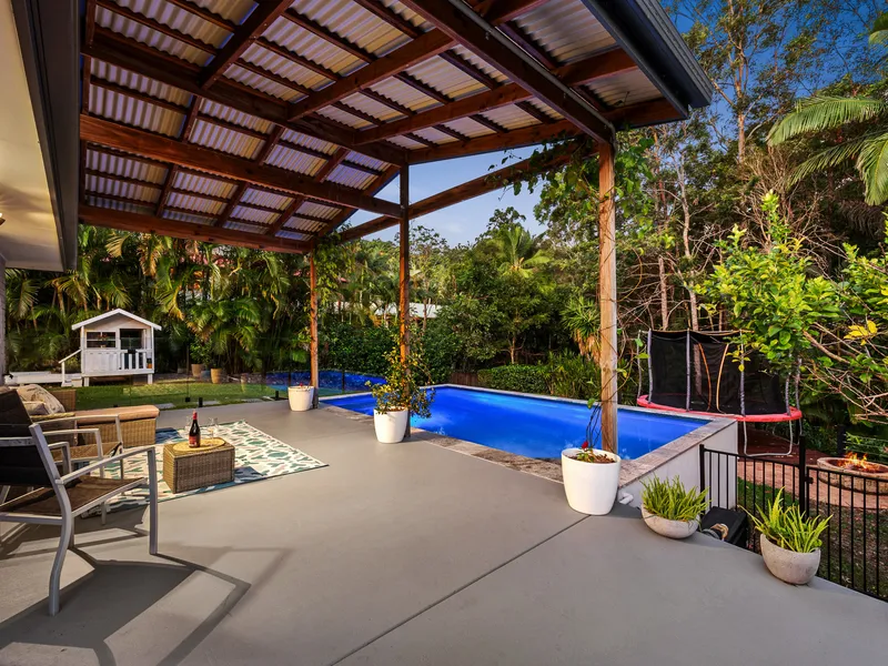 Ultimate Entertainer with sparkling pool and bush backdrop